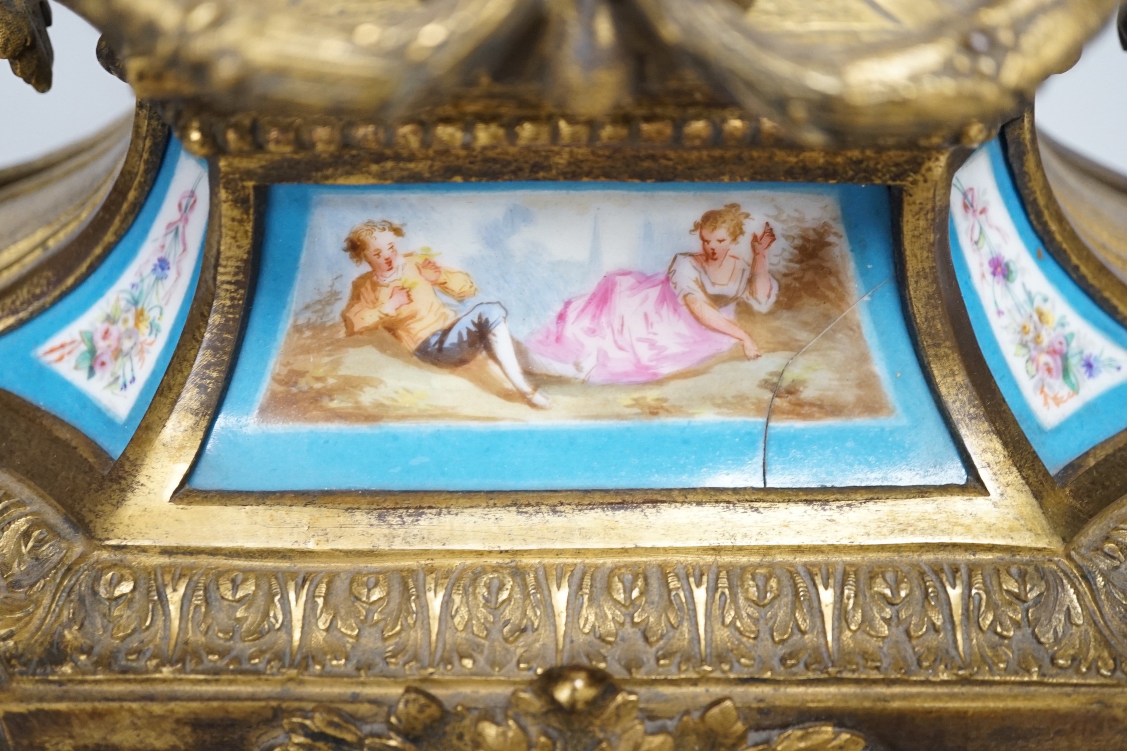 A 19th century French gilt-brass mantel clock with Sevres-style panels, 33cm